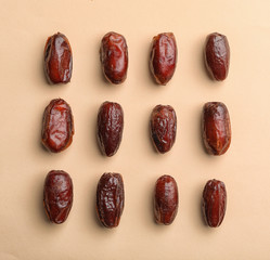 Sweet dried date fruits on color background, top view