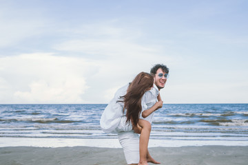 Happy relaxing couple in love on beach summer vacations.