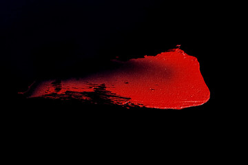 red lipstick texture with black background