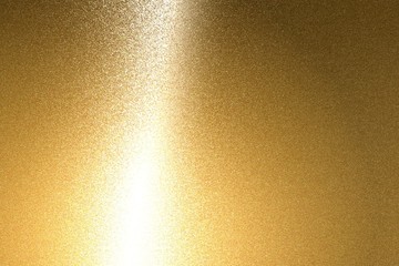 Light shining on brushed bronze metal plate texture, abstract background