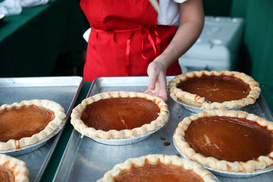 Hand reaching for Sweet potato honey pie on table