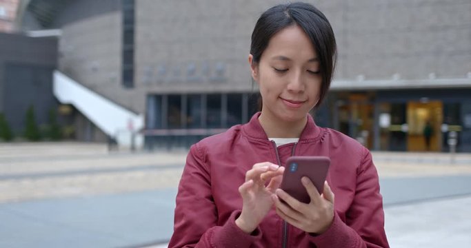 Woman check on cellphone in city