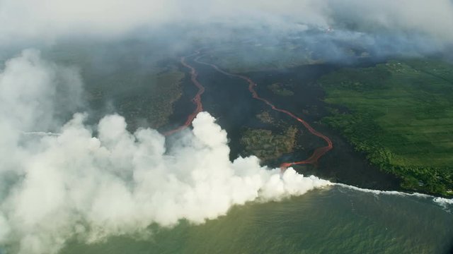 Aerial view molten lava pouring into Pacific ocean