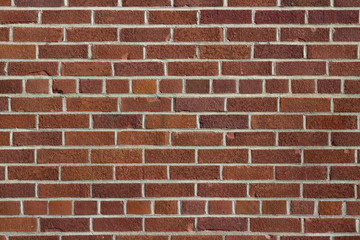 Grungy vintage reddish brown brick wall in common bond pattern