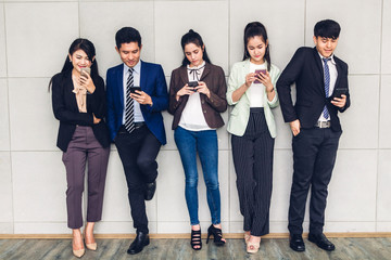 Group of business relax use technology together of smartphone  checking social apps and working.Communication concept