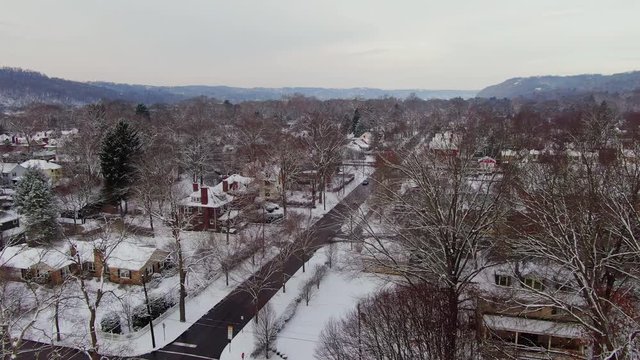 A slow forward winter aerial establishing shot of an upscale Pennsylvania residential neighborhood. Pittsburgh suburbs.  	