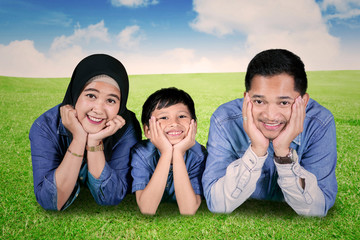 Muslim family lying together in the meadow