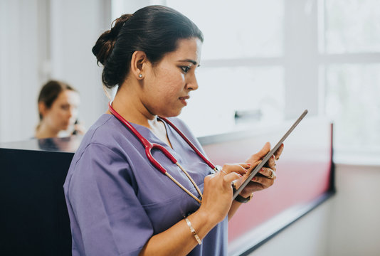 Female nurse checking the schedule on a tablet