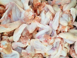 Top view of raw chicken wing as a background in the market for sale at Thailand, fresh meat for cooking