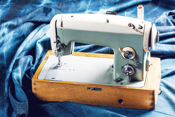 sewing indigo denim jeans with sewing machine, garment industrial concept.