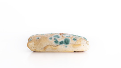 Old moldy bread on white background