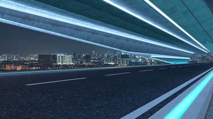 Fototapeta na wymiar Futuristic style highway road with blue neon light and cityscape background .