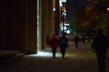 people walking on the street at night