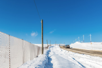 Snow fence along the road, winter scene