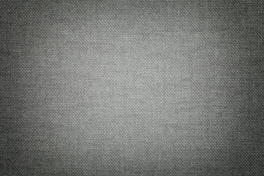 Dark gray background from a textile material with wicker pattern, closeup.