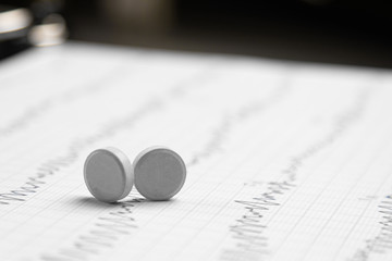 Two tablets on an electrocardiogram sheet