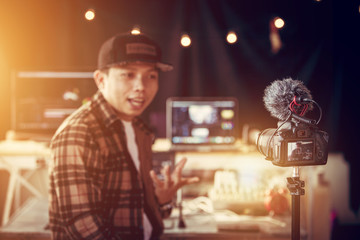 Asian male vlogger contents creator talking and looking in camera recording for blog