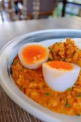 Rice served with fried Hepatopancreas shrimps and have boiled fever on top. The sauce is made from chili as a side dish. This is a typical Thai food.