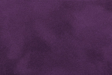 Dark purple matt suede fabric closeup. Velvet texture.
