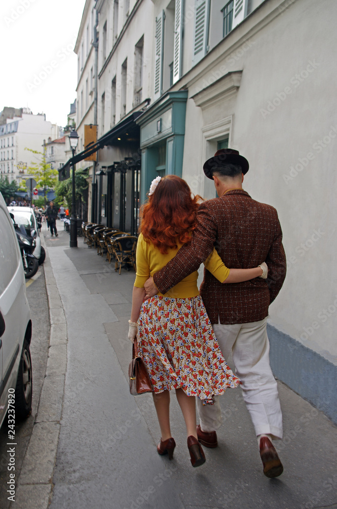 Wall mural a couple of lovers in paris walk down a street