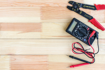 Electrical equipment and tools on wooden table with copy space.