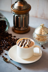 cup of coffee with whipped cream and beans