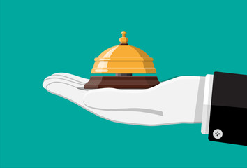 Golden service bell in hand