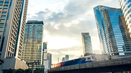 Cityscape building over clouds moving in business city Bangkok, Thailand