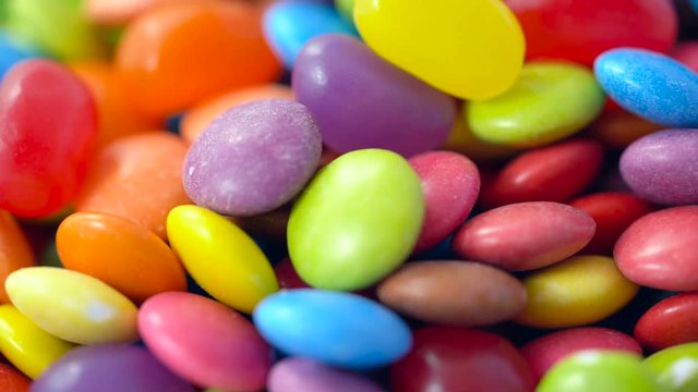 Macro closeup of multi color candy and jellies, dolly shot.