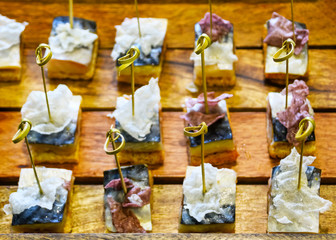 Catering Services Supply: Knots of Natural Bamboo Skewers in Mackerel Fish Canapes Placed in a Tray of Wooden Planks Served at a Business Event, Hotel, Birthday or Wedding Celebration