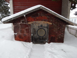 The door to the basement of an old house in winter
