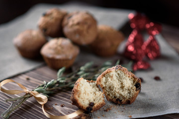 Homemade baking: Cupcakes with raisins sweets on linen cloth on a wooden background. 