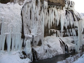 waterfall with huge beautiful icicles hanging from the rocks
