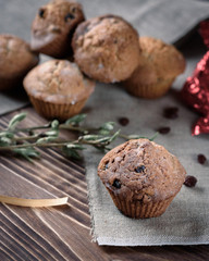 Homemade baking: Cupcakes with raisins sweets on linen cloth on a wooden background. 