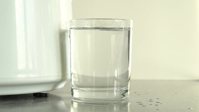Production of clean water or alcohol. Table home or chemical laboratory Distiller for production of pure water. Process of cleaning fluid. Alcohol mashine. Water dropping into glass. Close up