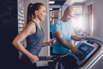 Personal training with a trainer on a treadmill
