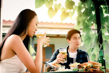 Women to toast a beer in the restaurant.