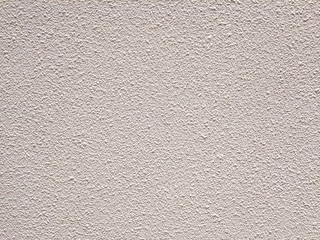 White, cream or beige background and Texture of natural cement wall with a rough surface. Exterior facade of a residential building.