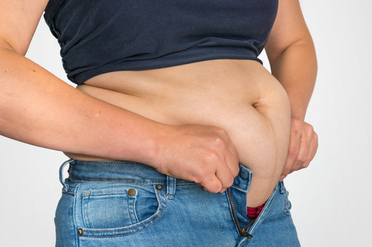 Overweight woman body with fat on belly - overweight concept