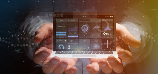 Businessman holding Laptop with business user interface data on the screen isolated on a background