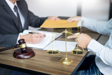 business people and lawyers discussing contract papers sitting at the table. Concepts of law, advice, legal services