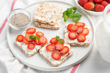 Rice crisp bread with strawberries and cottage cheese. Healthy breakfast food, dieting, fitness menu and kids food