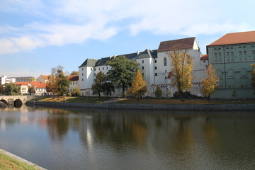Prácheňské museum on shore of Otava river with a part of Kamenný bridge in Písek, Czech republic,