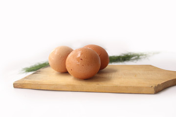 egg on a cutting board isolated on white 