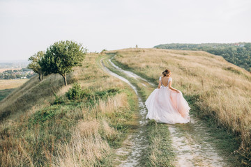 bride white dress outside running uphill turns