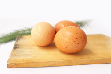 egg on a cutting board isolated on white 