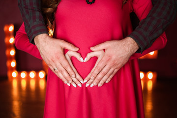 couple love together heart hands pregnant belly
