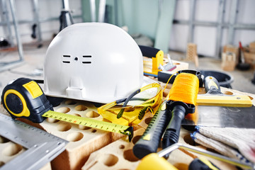 Home repairs. Construction tools, bricks and helmet
