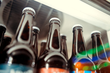 Beer bottles in ice cubes close up