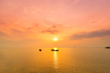 Naklejka na ściany i meble Beautiful sunrise on the beach and silhouette of fishing boat.Thailand.
